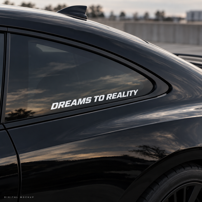 Digital mockup: Dreams To Reality white vinyl lettering on a black car window. Illustrative placement.